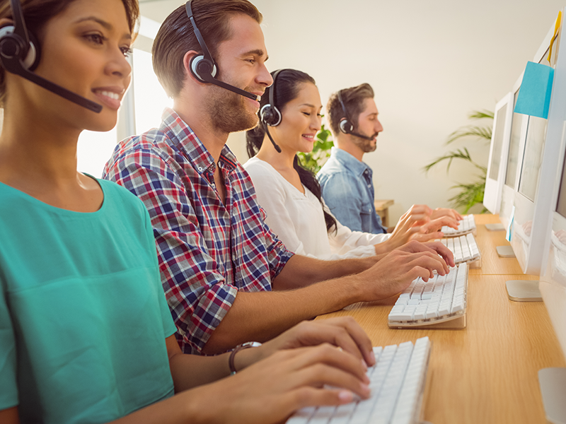 customer support agents in a call center taking calls from customers