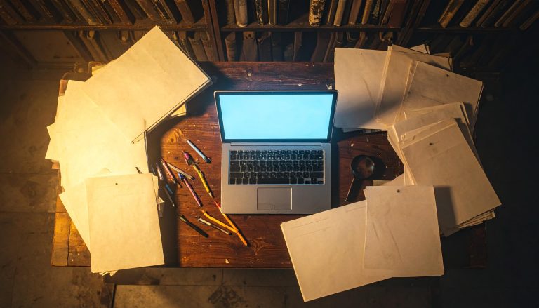 cluttered desk showing misplaced documents including transcripts and lost school records