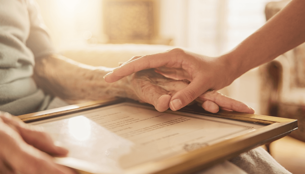 Framed diploma keepsake displayed alongside family photos