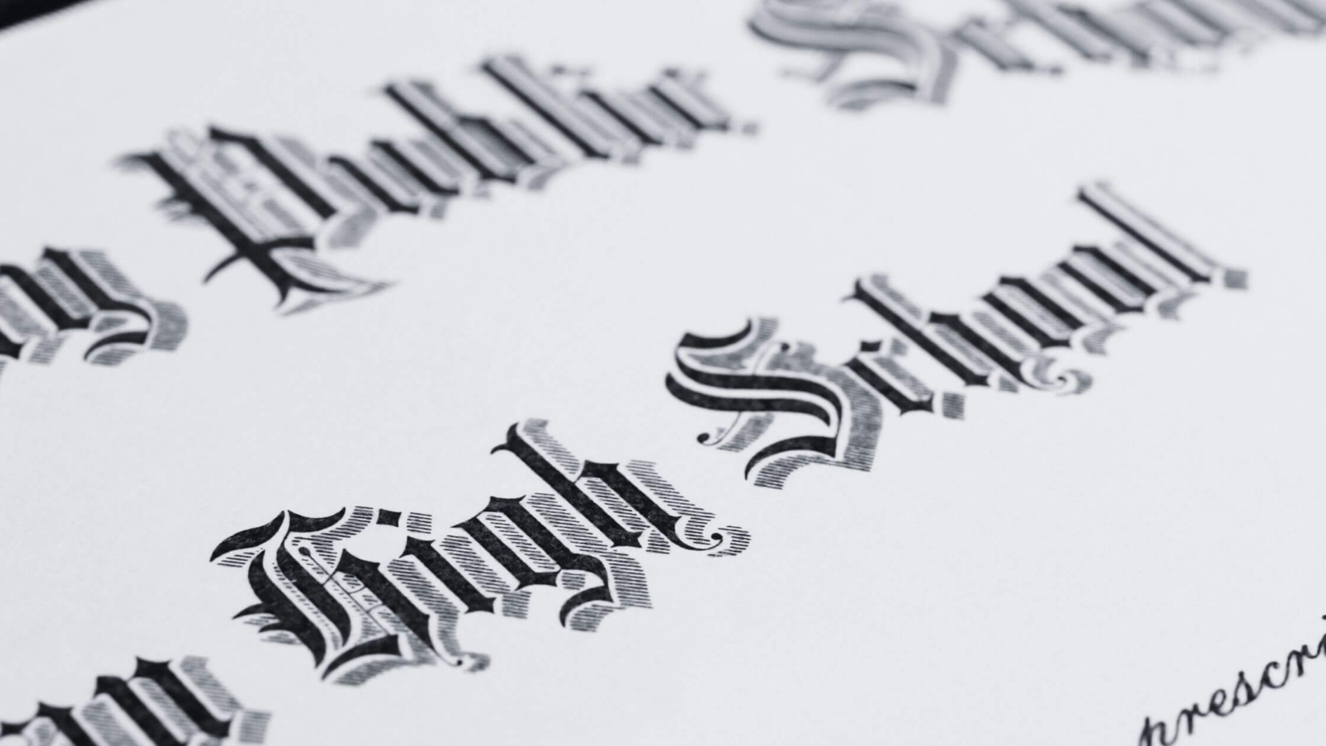 up close black and white image of a diploma from high school