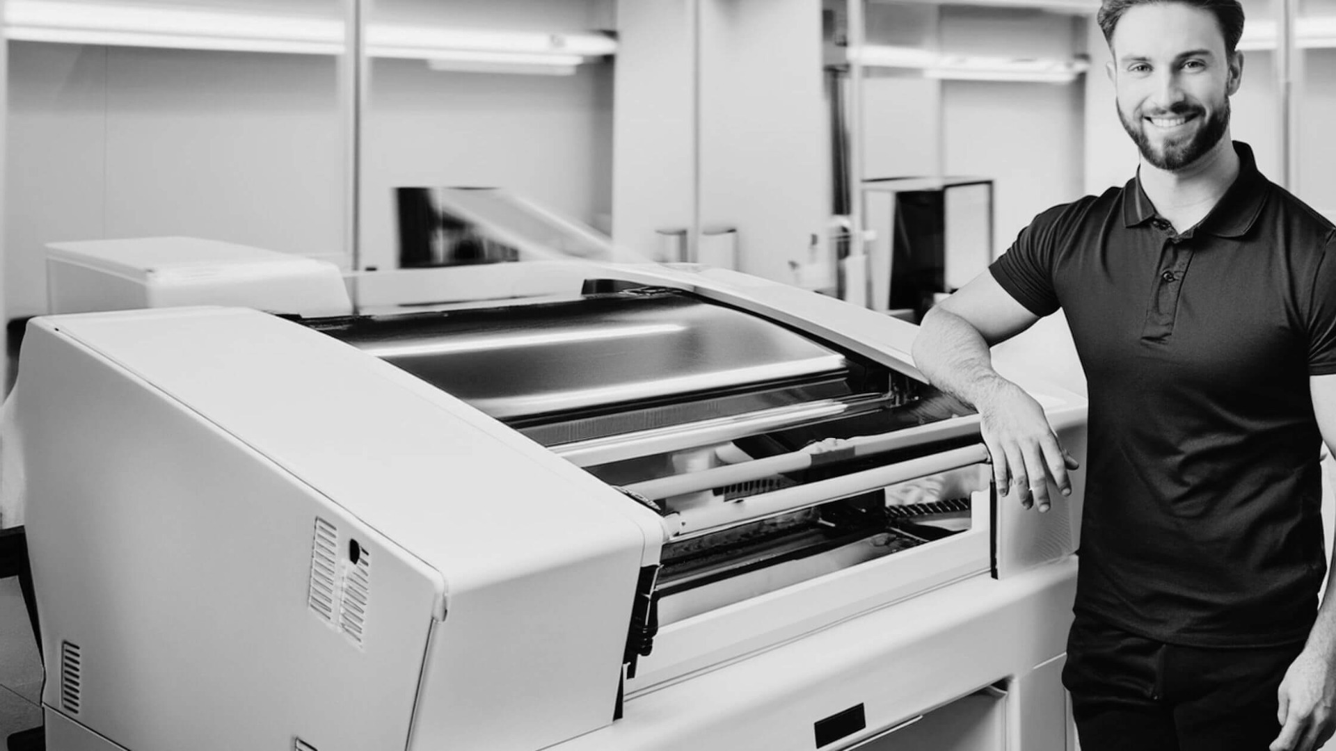 production staff next to diploma printing machine
